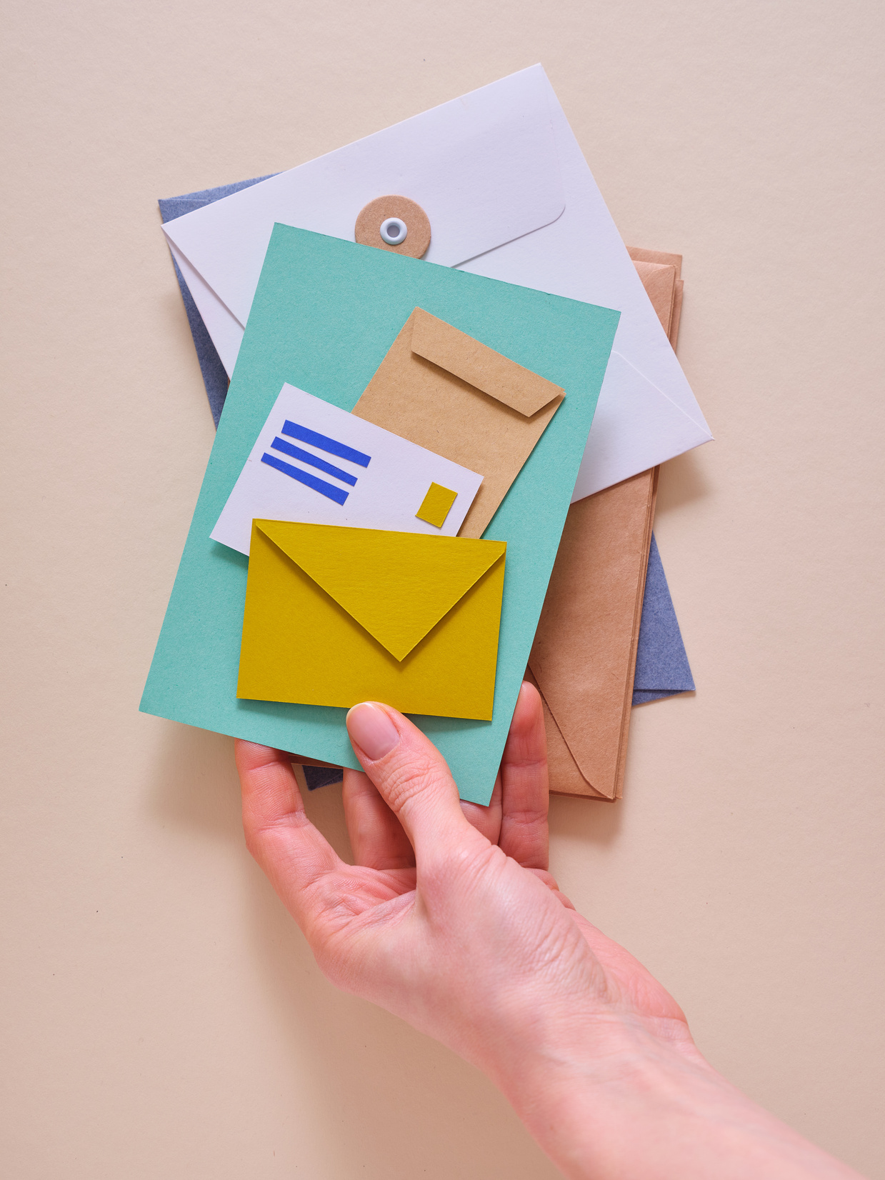 Handheld Paper Mail On Beige Background